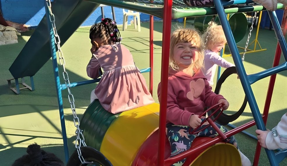 Children playing on the jungle gym at Toddies Preschool