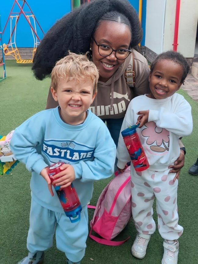 A teacher and two happy children on the Toddies playground