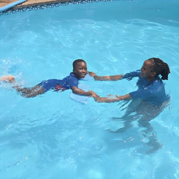 A Toddies child having a swimming lesson with a teacher in the on-site pool